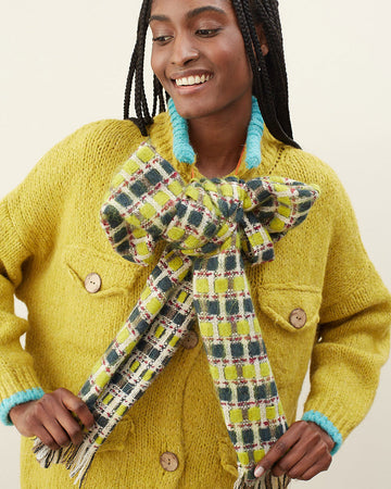 model wearing yellow and green checkered scarf