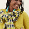 up close of model wearing yellow and green checkered scarf