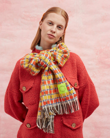 model wearing orange and yellow checkered scarf