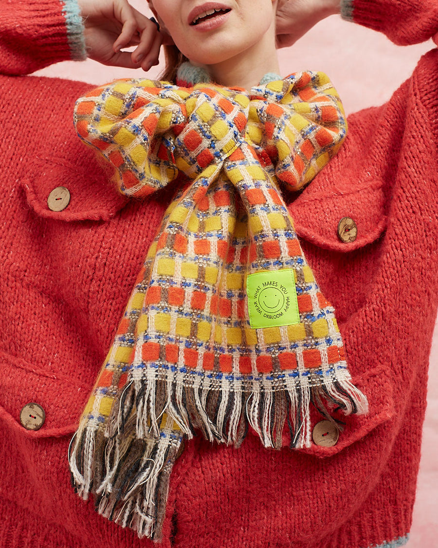 up close of model wearing orange and yellow checkered scarf