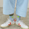 model wearing blue socks with neon smiley on the cuff