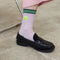 model wearing lilac socks with neon smiley cuff