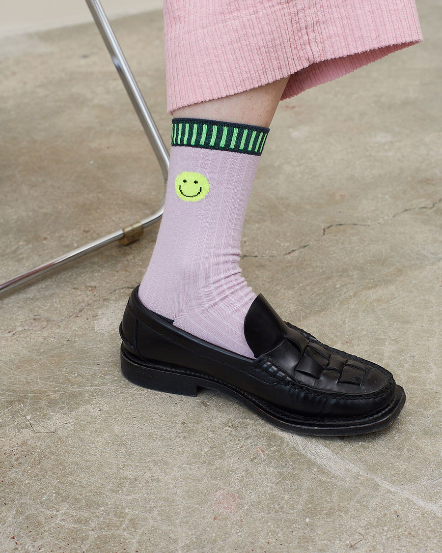 model wearing lilac socks with neon smiley cuff