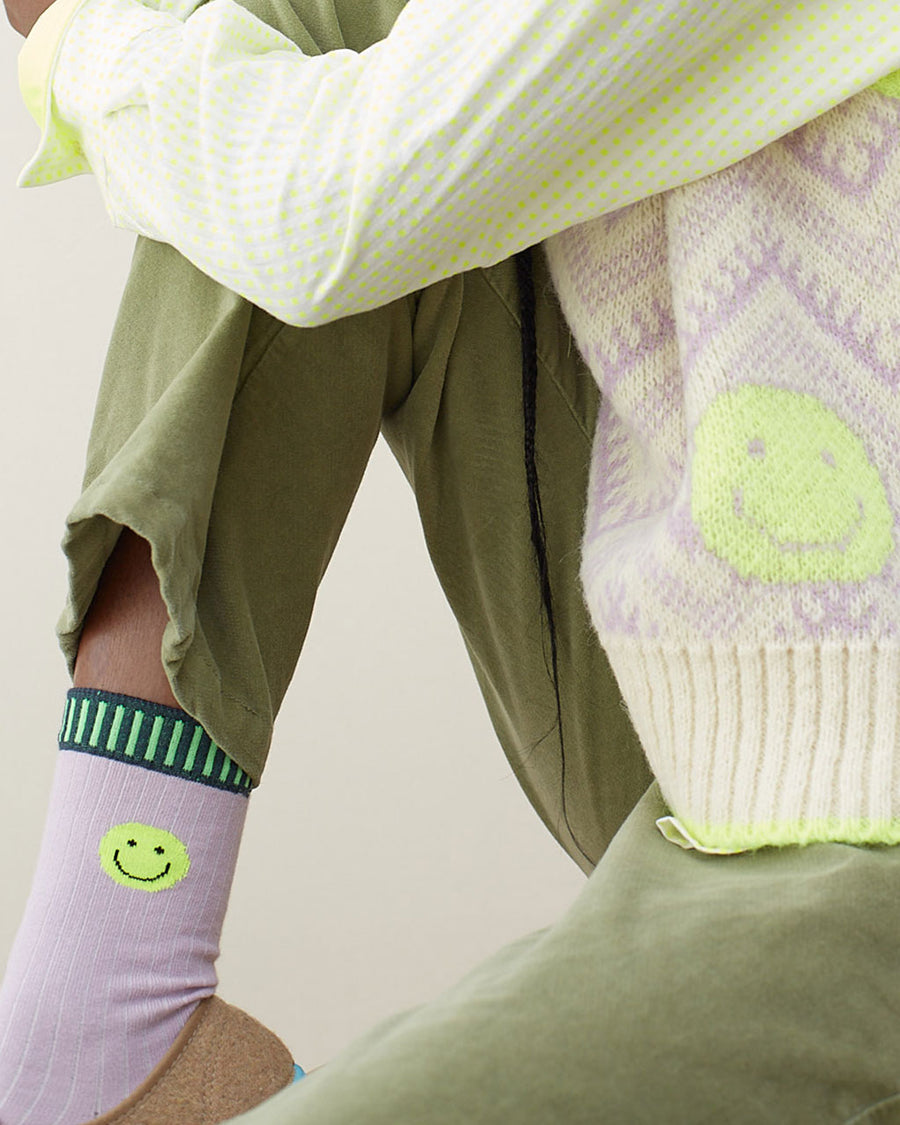 model wearing lilac socks with neon smiley cuff