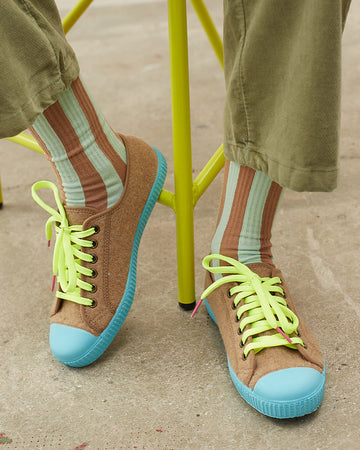 model wearing aqua and brown vertical stripe socks