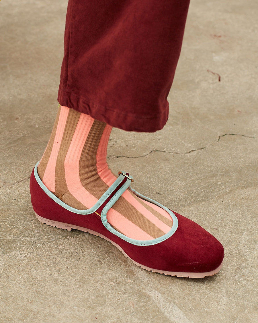 model wearing pink and brown vertical stripe socks