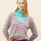 model wearing blue sweater with button funnel neckline and pink abstract floral print