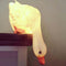 lit white duck looking down lamp