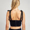 back view of model wearing navy velour cropped bustier tank with black tie straps and zip back