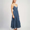 side view of model wearing denim midi dress with button front, spaghetti straps and o-ring back detail