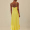 back view ofmodel wearing yellow dress with criss cross bodice and knots in the straps