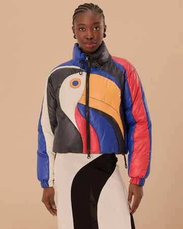 model wearing reversible puffer jacket with colorful toucan face