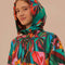 model wearing hood of colorful long raincoat