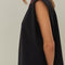 side view of model wearing black cap sleeve top with red beaded heart shapes around the neckline