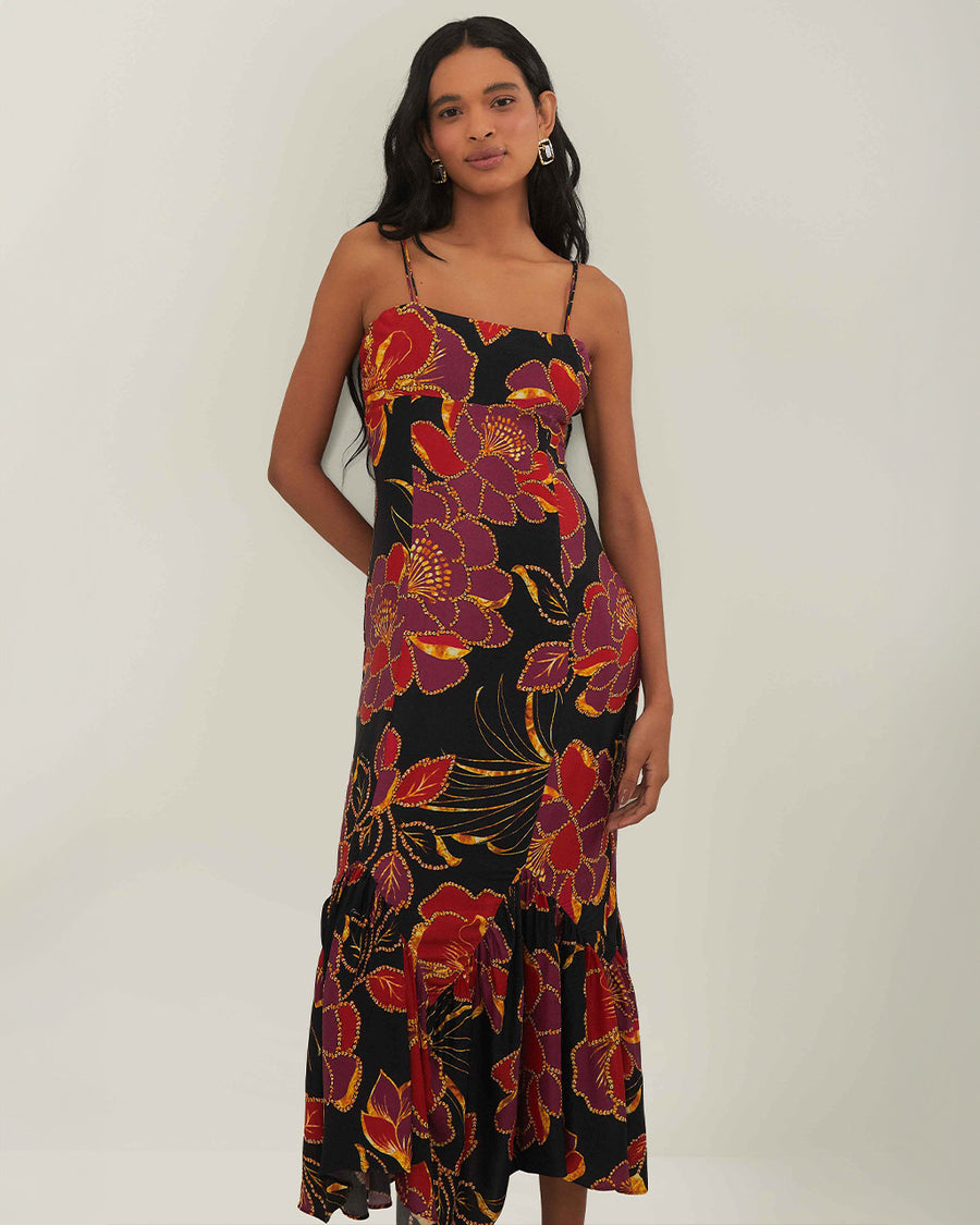 model wearing black tank maxi dress with red and purple flowers with gold accents