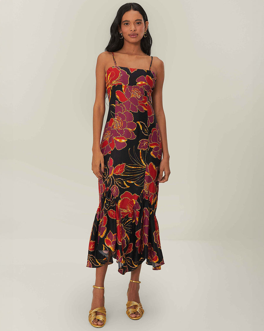 model wearing black tank maxi dress with red and purple flowers with gold accents