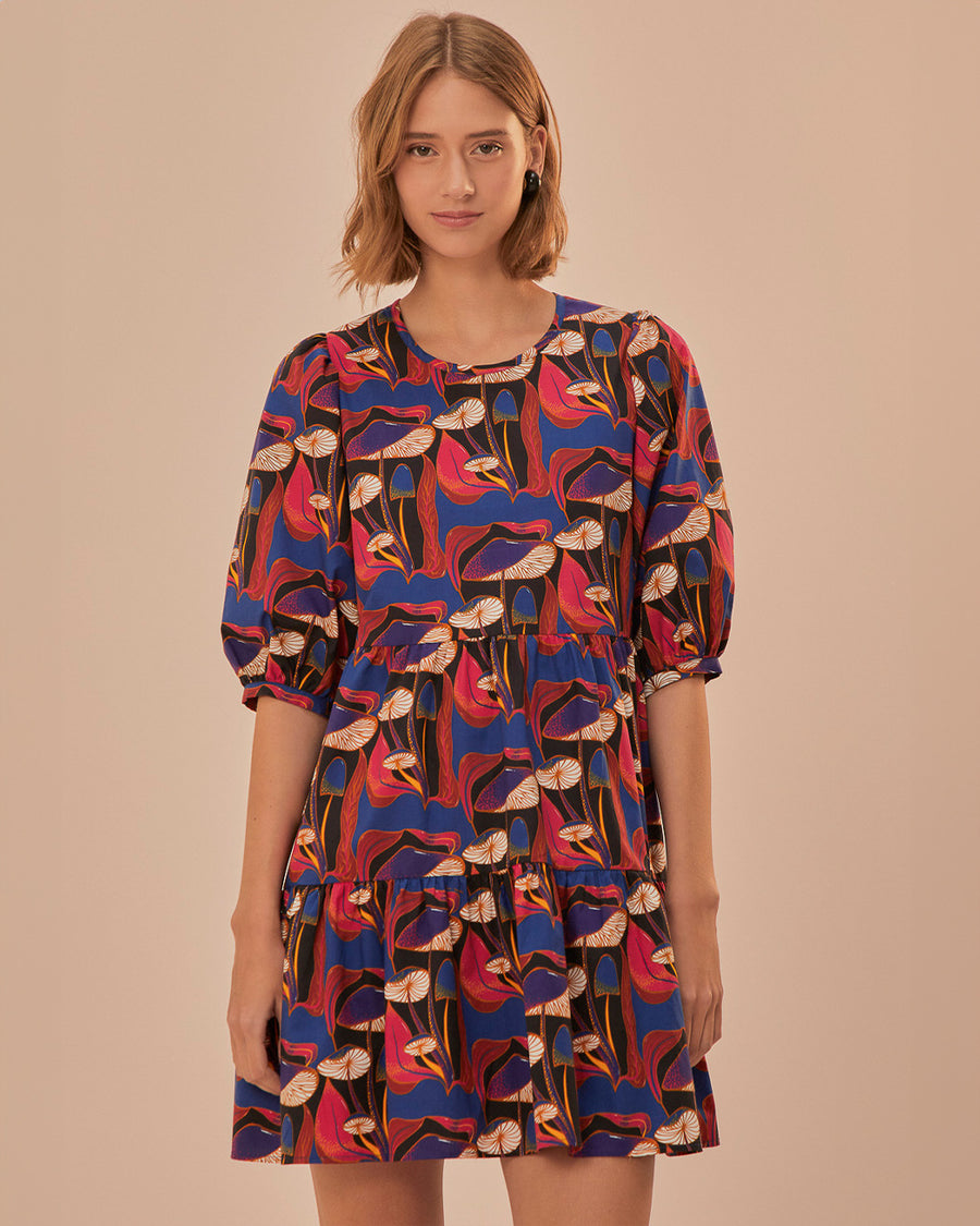 model wearing black mini dress with blue, red and cream wild mushroom print and puff short sleeves