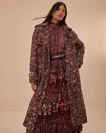 model wearing red, burgundy and cream ditsy floral midi trench coat