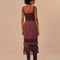 back view of model wearing purple midi dress with crochet bodice and floral skirt with lace and crochet details