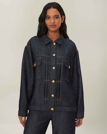 model wearing shimmery blue denim jacket with button front and patch front pockets