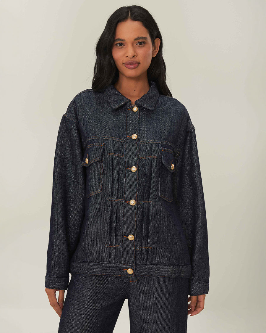 model wearing shimmery blue denim jacket with button front and patch front pockets