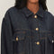 up close of model wearing shimmery blue denim jacket with button front and patch front pockets