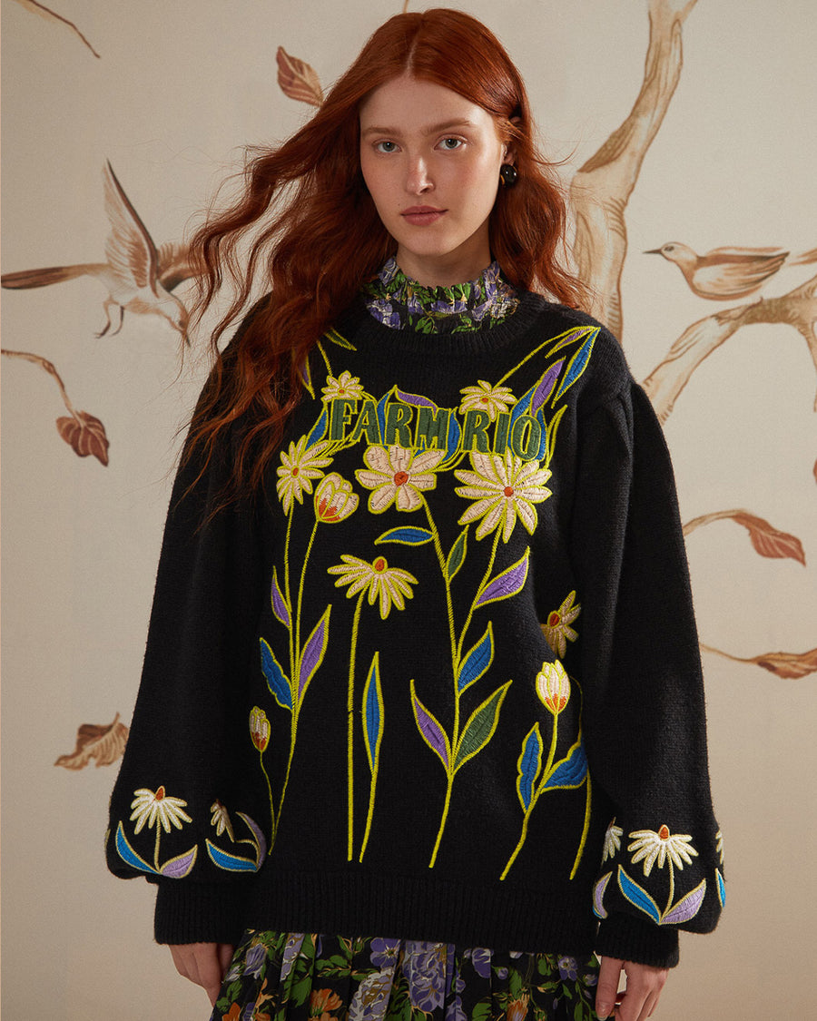 model wearing black relaxed fit sweater with embroidered 'farm rio' and flowers