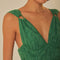 up close of model wearing emerald green eyelet midi dress with deep V neckline and o-ring straps