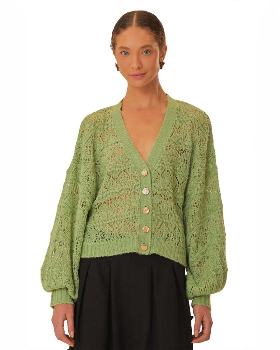 model wearing light green textured open knit cardigan