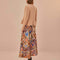 back view of model wearing sand midi skirt with colorful abstract heart and ikat prints