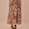 model wearing sand midi skirt with colorful abstract heart and ikat prints