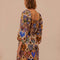 back view of model wearing square neck mini dress with sand ground and colorful ikat heart print and long puff sleeves