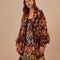 model wearing colorful abstract heart knit cardigan sweater with slight blouson sleeves and blazer collar