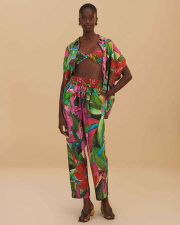 model wearing colorful tropical floral print with beaded tassel tie waist and side pockets