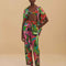 model wearing colorful tropical floral print with beaded tassel tie waist and side pockets