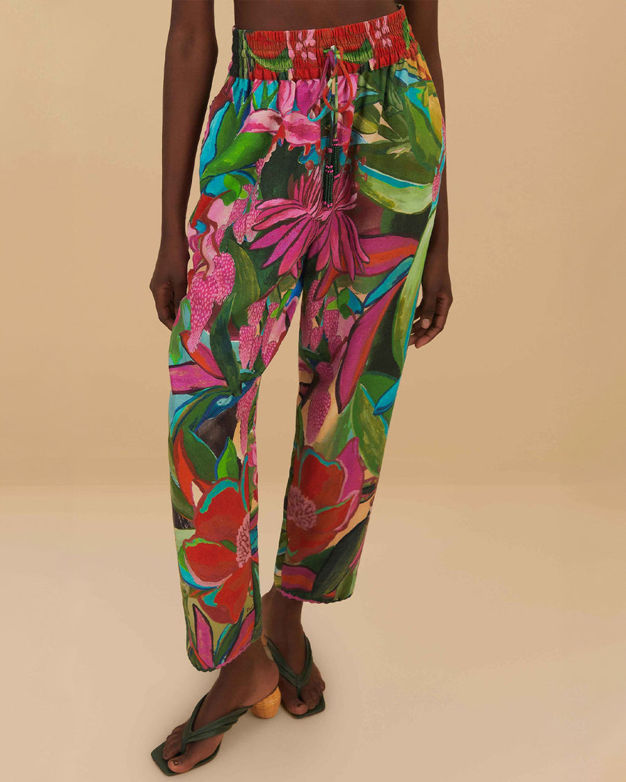 model wearing colorful tropical floral print with beaded tassel tie waist and side pockets