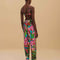 back view of model wearing colorful tropical floral print with beaded tassel tie waist and side pockets