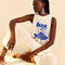 model wearing cream cotton jumpsuit with blue 'mar da bahia' and fish graphic on front