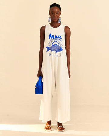 model wearing cream cotton jumpsuit with blue 'mar da bahia' and fish graphic on front