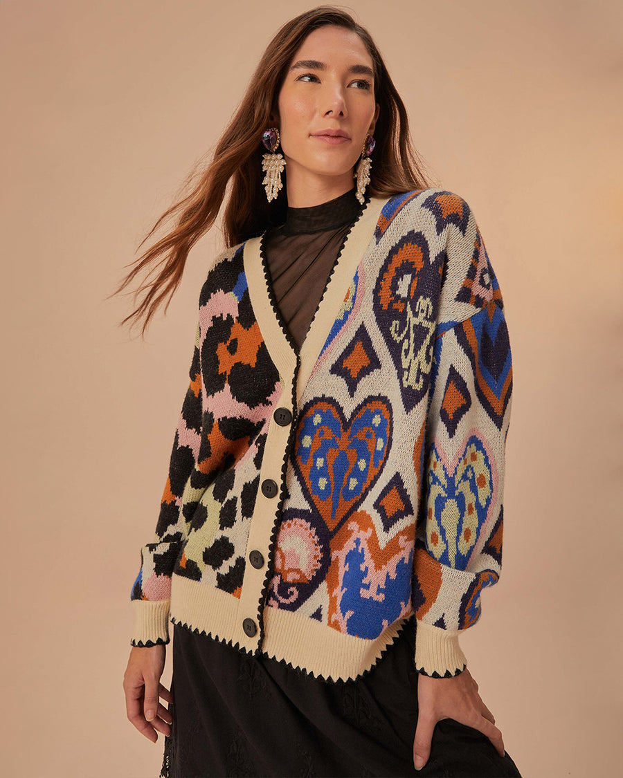 model wearing cream cardigan with black trim and colorful leopard and abstract heart print