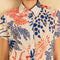 up close of model wearing off white short sleeve button down top with blue and red abstract lobster print