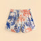 off white cotton shorts with red and blue abstract lobster print paired with matching top