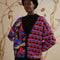 model wearing split cardigan with blue abstract mushroom print and red, blue and black wavy print