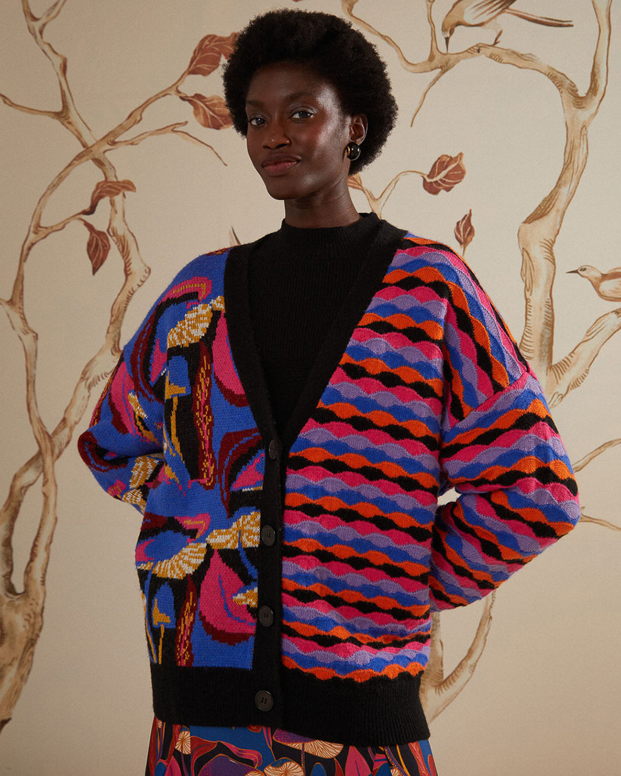 model wearing split cardigan with blue abstract mushroom print and red, blue and black wavy print