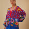 model wearing relaxed fit cardigan with colorful waves, colorful leopard print and colorful abstract fruit print