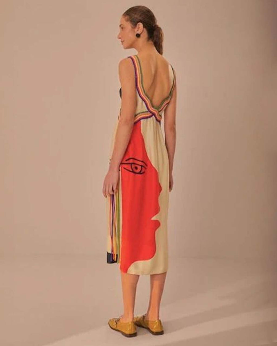 back view of model wearing black midi dress with cream face silhouette on the side and colorful rope trim along the straps and bodice