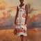 model wearing white midi dress with scalloped bodice and straps , cut out waist, and all over colorful floral print