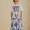 model wearing white midi skirt with blue leaf print and tie waist