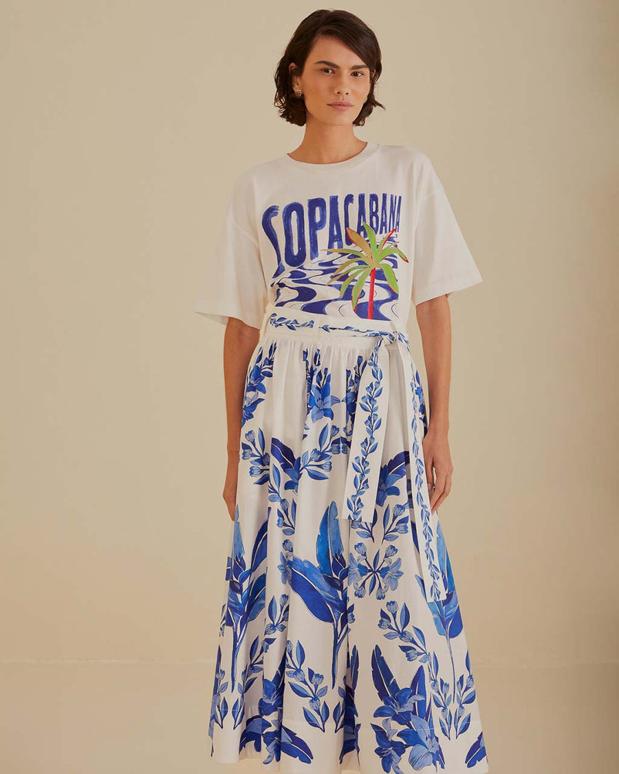 model wearing white midi skirt with blue leaf print and tie waist