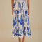 up close of model wearing white midi skirt with blue leaf print and tie waist